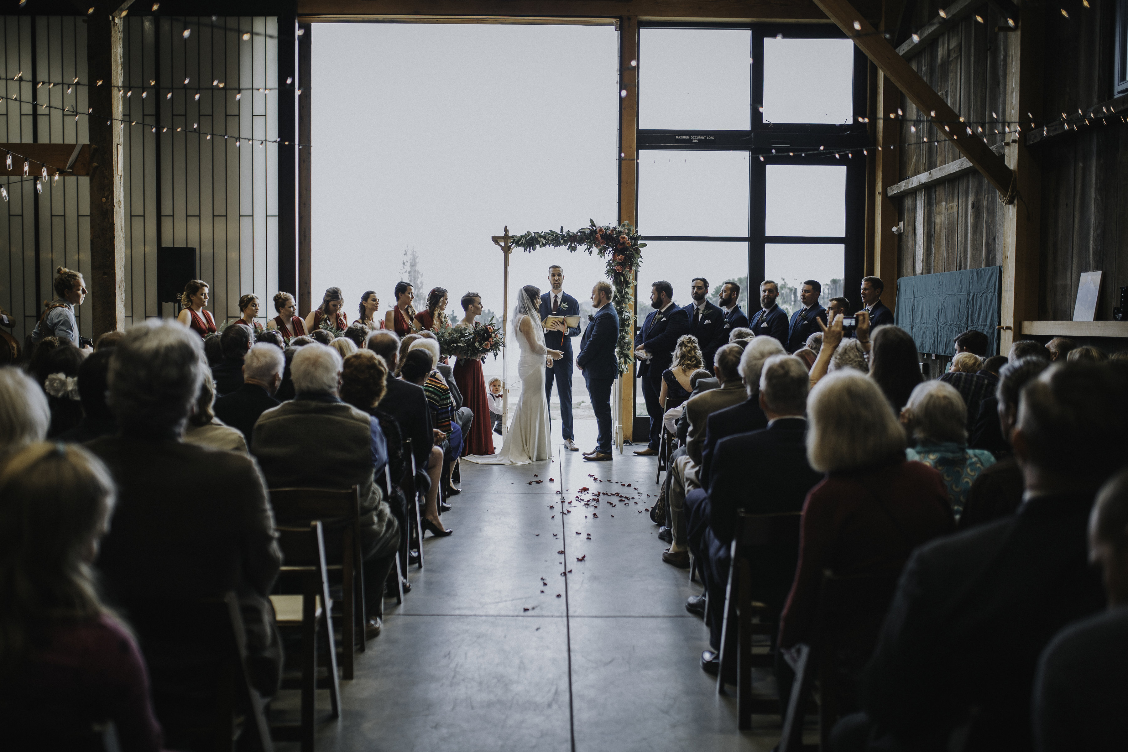 wedding ceremony inside hay barn